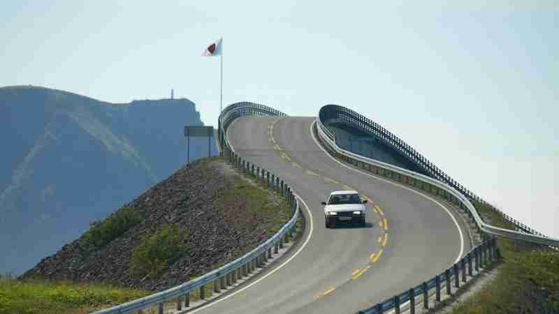 A car driving on the iconic Atlantic Ocean Road with coastal views and winding architecture., tags: hidden gems - pexel